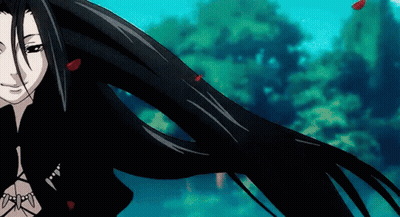 A Woman With Long Black Hair Is Blowing In The Wind GIF