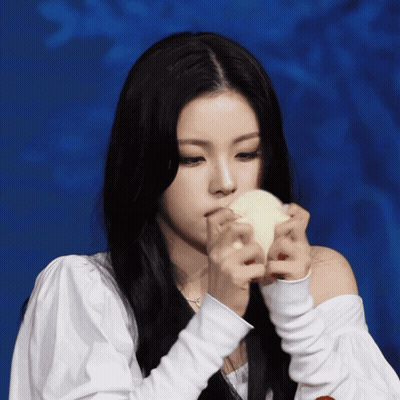 A Woman With Long Black Hair Is Holding A White Object GIF