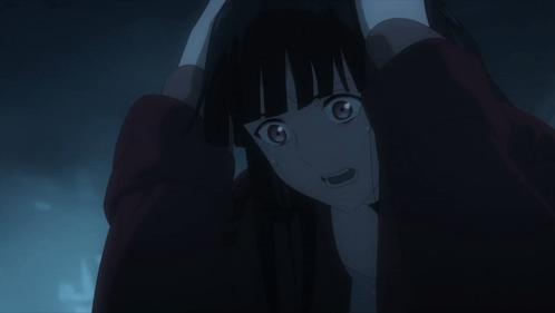 A Woman With Long Black Hair Is Holding Her Head In Her Hands GIF