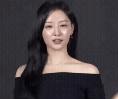 A Woman With Long Black Hair Is Wearing A Black Off The Shoulder Top GIF