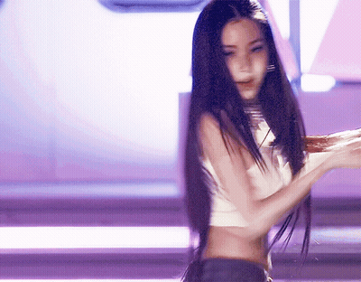 A Woman With Long Black Hair Is Wearing A Crop Top GIF