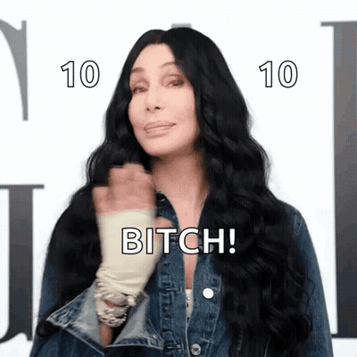 A Woman With Long Black Hair Is Wearing A Denim Jacket And Says Bitch ! GIF