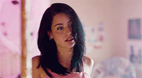 A Woman With Long Black Hair Is Wearing A Pink Dress And A Choker . GIF