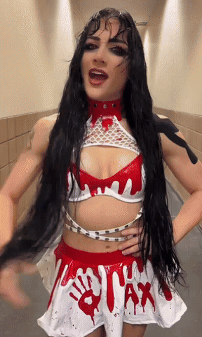 A Woman With Long Black Hair Is Wearing A White And Red Outfit That Says Wax On It GIF