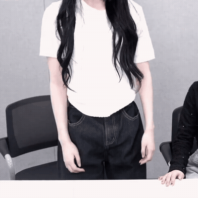 A Woman With Long Black Hair Is Wearing A White Shirt GIF