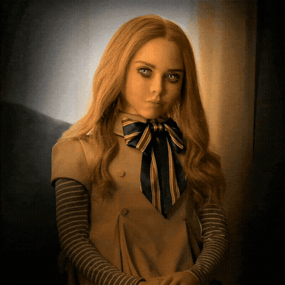 A Woman With Long Blonde Hair And A Bow Tie GIF