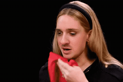 A Woman With Long Blonde Hair And A Headband Is Making A Funny Face And Asking What Do You . GIF