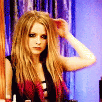 A Woman With Long Blonde Hair Holds Her Hand To Her Forehead GIF