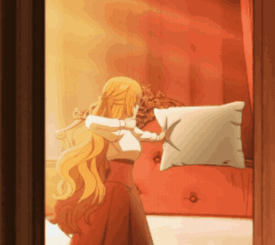 A Woman With Long Blonde Hair Is Holding A Pillow In Front Of A Red Couch GIF