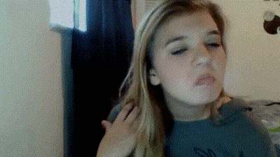 A Woman With Long Blonde Hair Is Making A Funny Face With Her Hand On Her Shoulder GIF