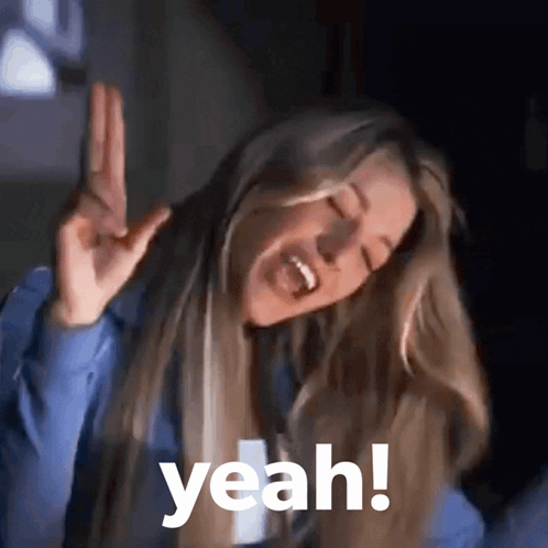 A Woman With Long Blonde Hair Is Making A Peace Sign And The Word Yeah Is Above Her GIF