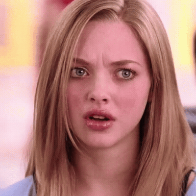 A Woman With Long Blonde Hair Is Making A Surprised Face . GIF