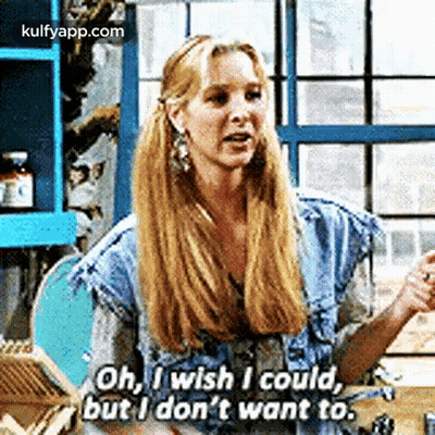 A Woman With Long Blonde Hair Is Sitting At A Table And Talking To A Man . GIF