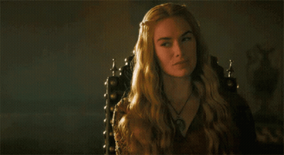 A Woman With Long Blonde Hair Is Sitting In A Chair GIF