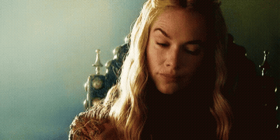 A Woman With Long Blonde Hair Is Sitting In A Chair With Her Eyes Closed And A Crown On Her Head . GIF