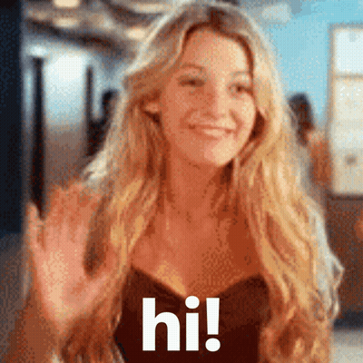 A Woman With Long Blonde Hair Is Waving Her Hand And The Words Hi Are Visible GIF