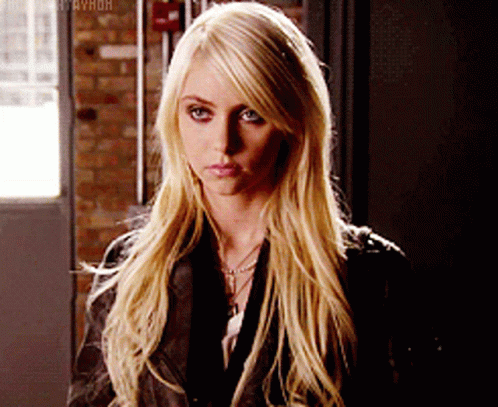 A Woman With Long Blonde Hair Is Wearing A Black Leather Jacket GIF