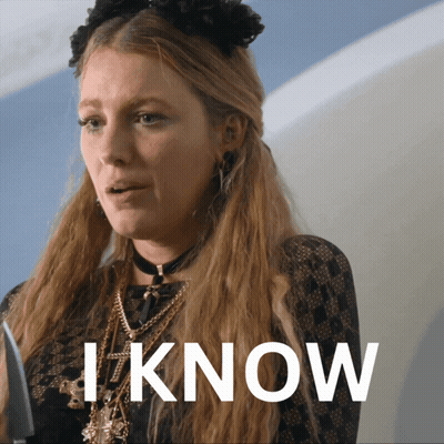 A Woman With Long Blonde Hair Is Wearing A Choker And Necklaces And The Word I Know Is Behind Her GIF