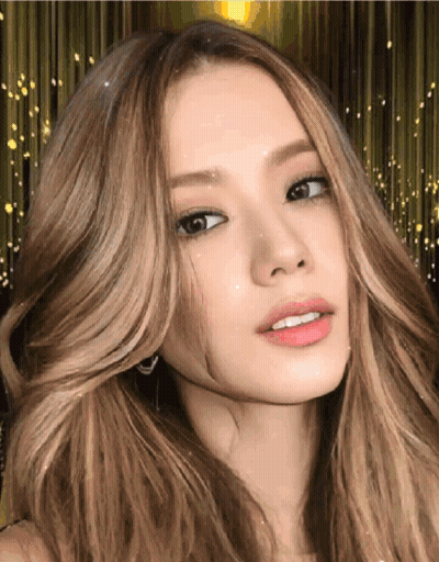 A Woman With Long Blonde Hair Looks At The Camera GIF