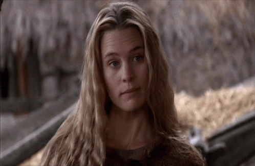 A Woman With Long Blonde Hair Looks At The Camera With A Sad Look On Her Face GIF