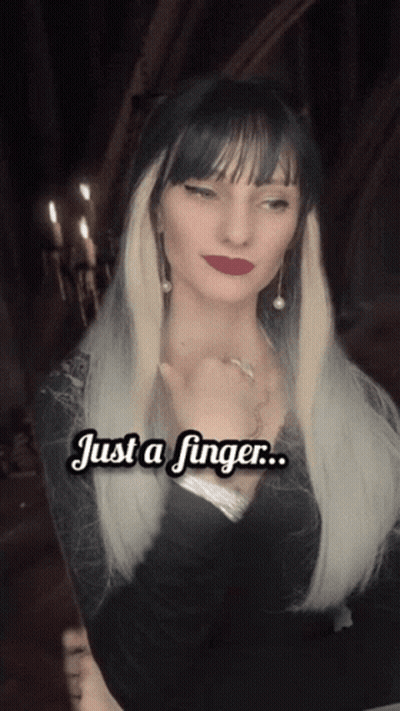 A Woman With Long Blonde Hair Says " Just A Finger " In White Letters GIF