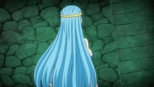 A Woman With Long Blue Hair Stands In Front Of A Green Wall GIF