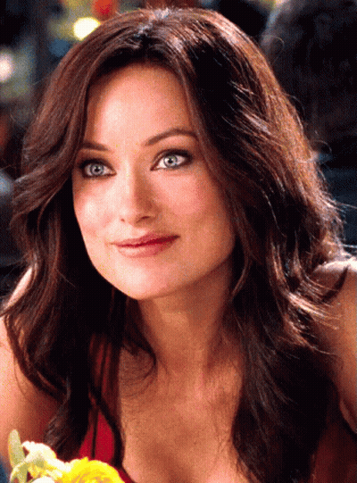 A Woman With Long Brown Hair And Blue Eyes GIF