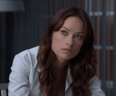 A Woman With Long Brown Hair And Blue Eyes Wearing A White Shirt GIF