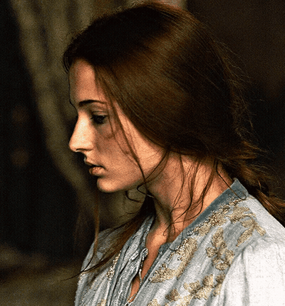 A Woman With Long Brown Hair Is Wearing A Blue Shirt GIF