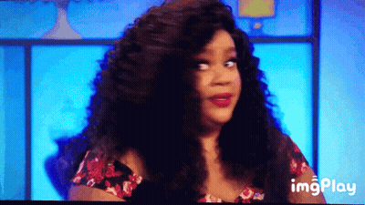 A Woman With Long Curly Hair Is On A Television Screen With A Blue Background And The Words Imgplay Below Her GIF