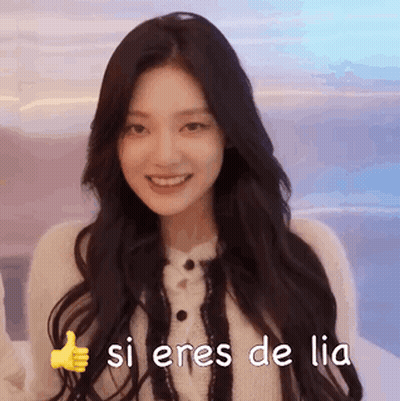 A Woman With Long Dark Hair Is Smiling And Giving A Thumbs Up Sign . GIF