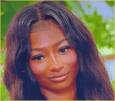A Woman With Long Dark Hair Is Smiling For The Camera GIF