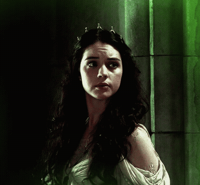 A Woman With Long Dark Hair Wearing A Tiara On Her Head GIF