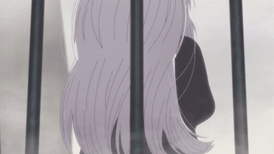 A Woman With Long Gray Hair Behind Bars GIF