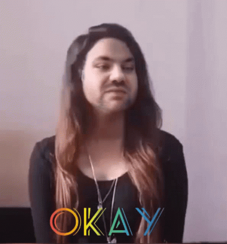 A Woman With Long Hair And A Beard Has The Word Okay Written On Her Face GIF