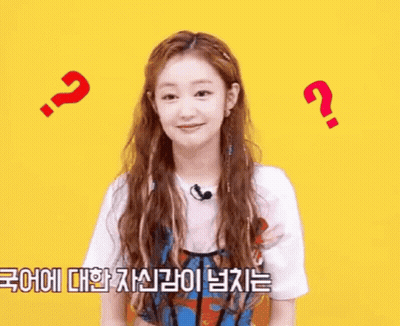 A Woman With Long Hair And A Microphone Is Surrounded By Question Marks And A Foreign Language . GIF