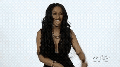 A Woman With Long Hair And A Necklace Is Smiling And Dancing . GIF