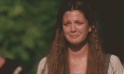 A Woman With Long Hair And Braids Is Crying GIF