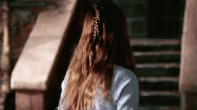 A Woman With Long Hair Has A Braided Ponytail GIF