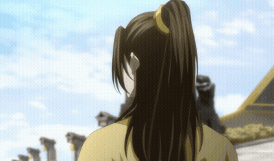 A Woman With Long Hair In A Ponytail Is Standing In Front Of A Building GIF