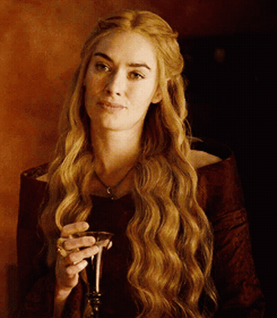 A Woman With Long Hair Is Holding A Glass Of Wine GIF