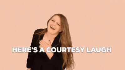 A Woman With Long Hair Is Laughing With The Words `` Here 'S A Courtesy Laugh '' Above Her . GIF