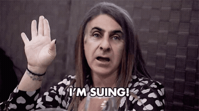 A Woman With Long Hair Is Making A Funny Face And Saying `` I 'M Suing ! '' GIF