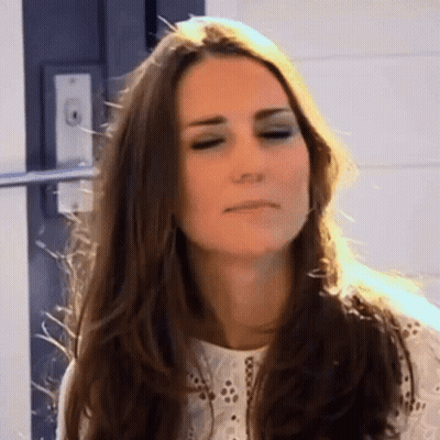 A Woman With Long Hair Is Making A Funny Face . GIF