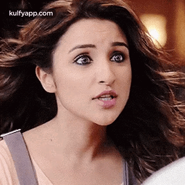 A Woman With Long Hair Is Making A Funny Face . GIF