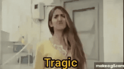 A Woman With Long Hair Is Making A Funny Face While Standing In Front Of A Door . GIF