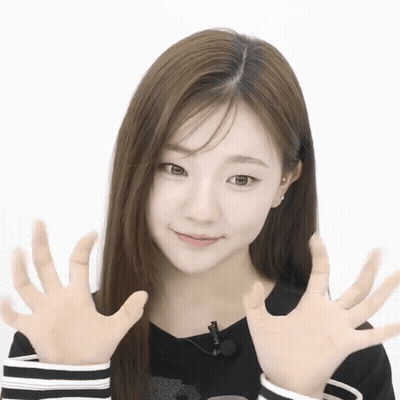 A Woman With Long Hair Is Making A Funny Face With Her Hands In Front Of Her Face GIF