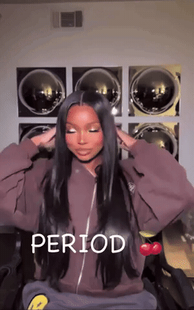 A Woman With Long Hair Is Sitting In Front Of A Washing Machine With The Word Period Written On The Bottom GIF