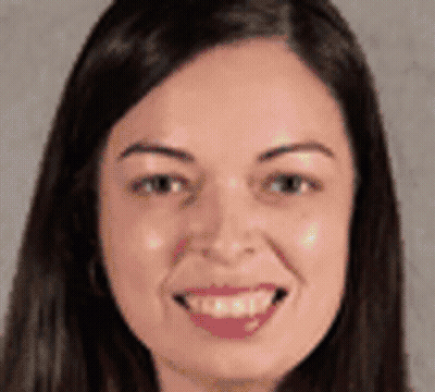 A Woman With Long Hair Is Smiling For The Camera . GIF