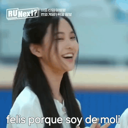 A Woman With Long Hair Is Smiling With The Words Felis Porque Soy De Moli Below Her GIF